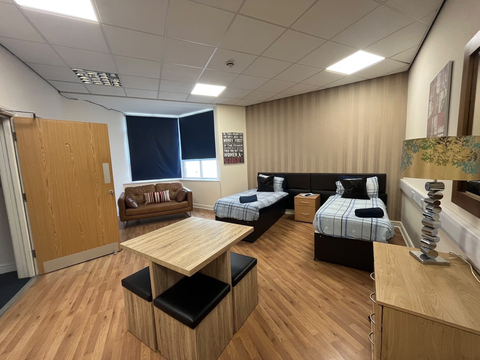 The Super Double with twin beds, a leather sofa and a dining table